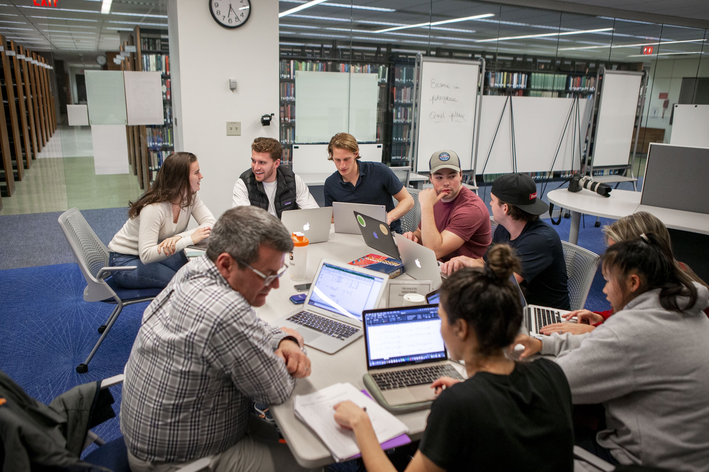 Students with laptops working around a table