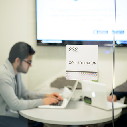 Students working in a collaboration room in Shain Library.