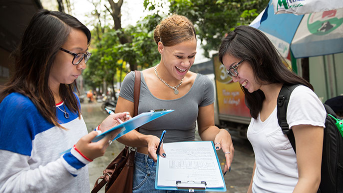 Three students sharing notes on a SATA Vietnam trip