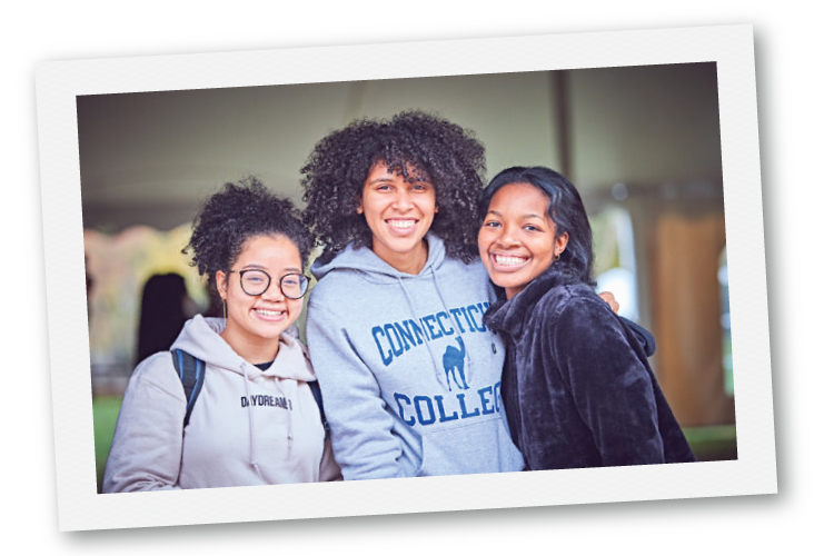 Three students smiling