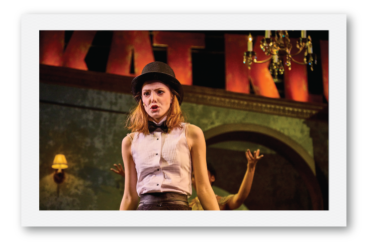 Girl in a top hat during a theater performance