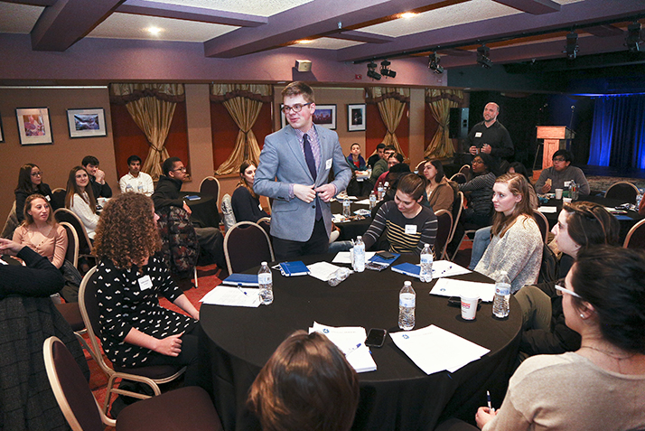 A student stands up in the middle of the room at the Emerging Leaders Conference.