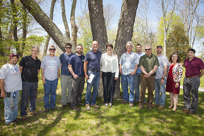 At center, Jim Luce (Citizenship Award), grounds supervisor, and President Katherine Bergeron, along with facilities staff. 