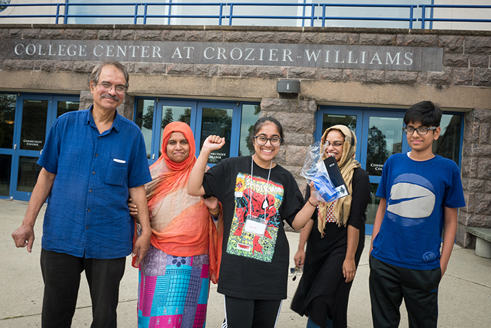 A student poses with her family. 