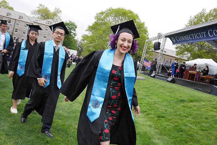 A student proceeds to the stage to receive her diploma.