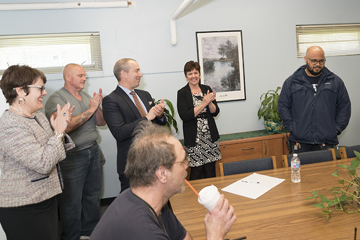 Custodian Working Leader Angelo Urena is surprised with the Service Excellence Award. 