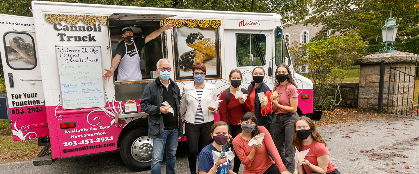 President Katherine Bergeron and Butch Rovan with students in front of the Cannoli truck.