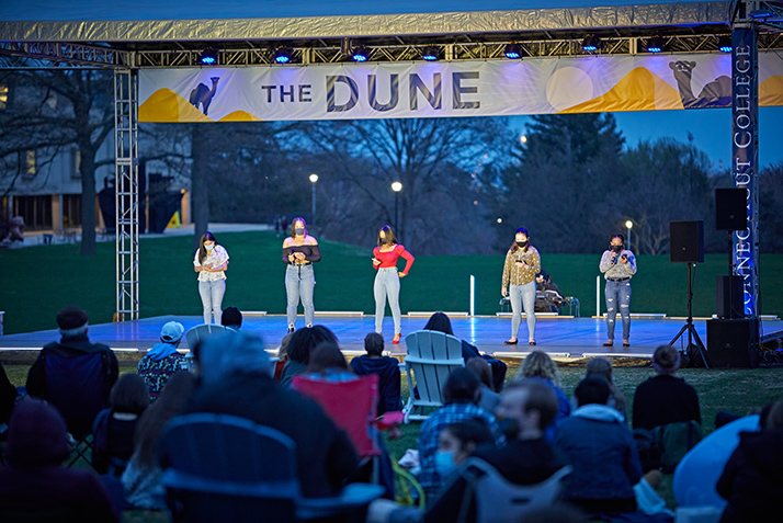 Students perform under lights. 