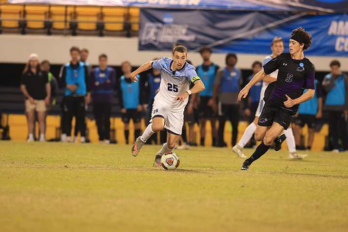 An action shot of a player dribbling the ball. 