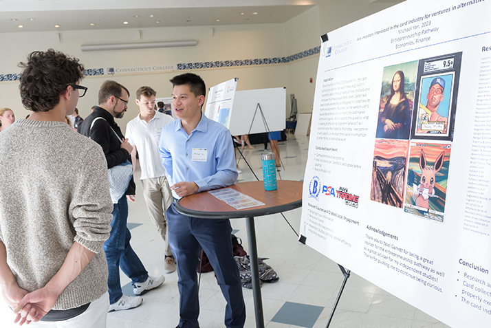 A student presents a poster at the ACS poster session.