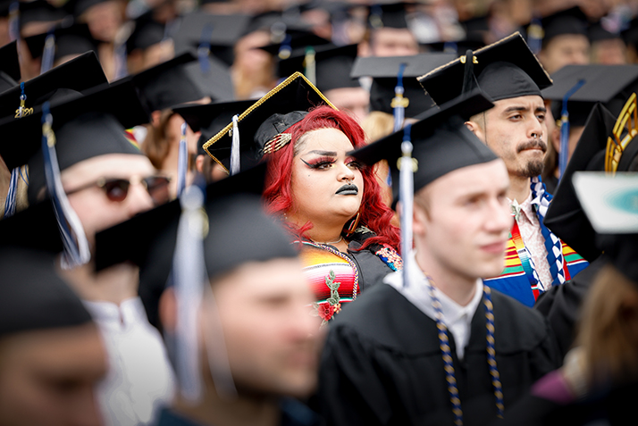 A student watches the proceedings from the crowd