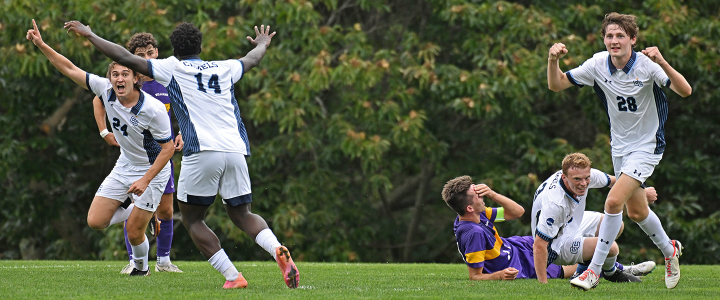 Members of the mens soccer team celebrate a goal during a match.