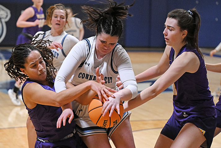 Basketball players battle for a rebound