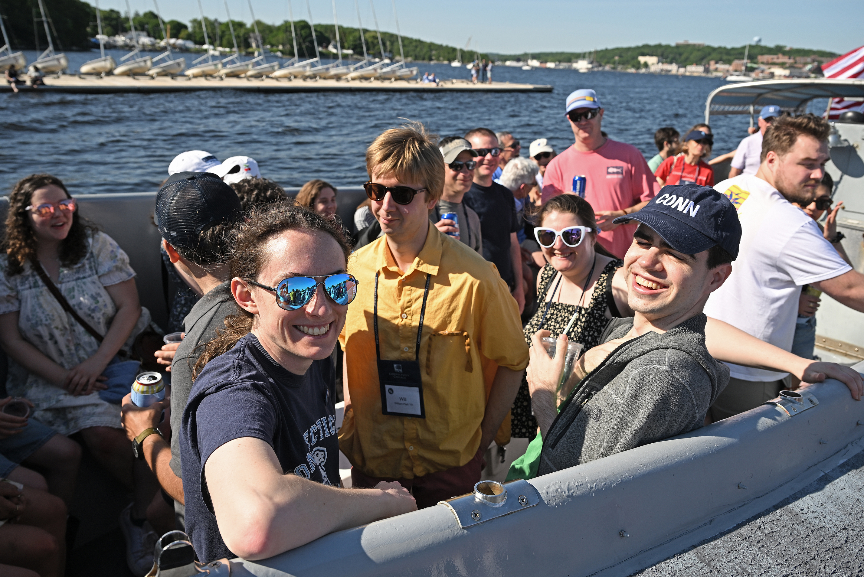 A group of people gather on board a boat for a harbor tour