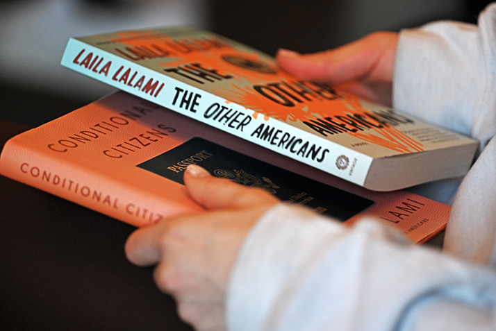 A student holds copies of Laila Lalami's books.