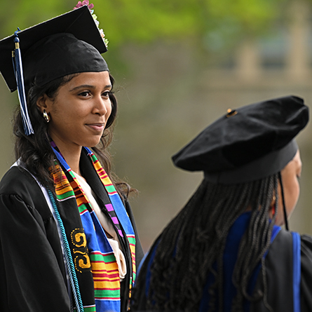 Jasity Mena on stage as Dean of the College Erika Smith reads her award citation.