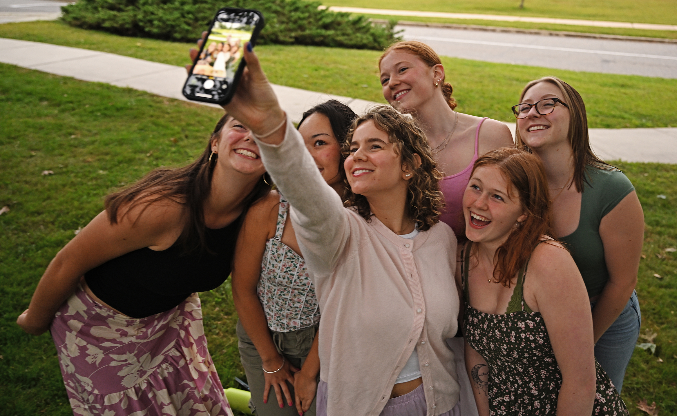 A group of students take a selfie photo together.