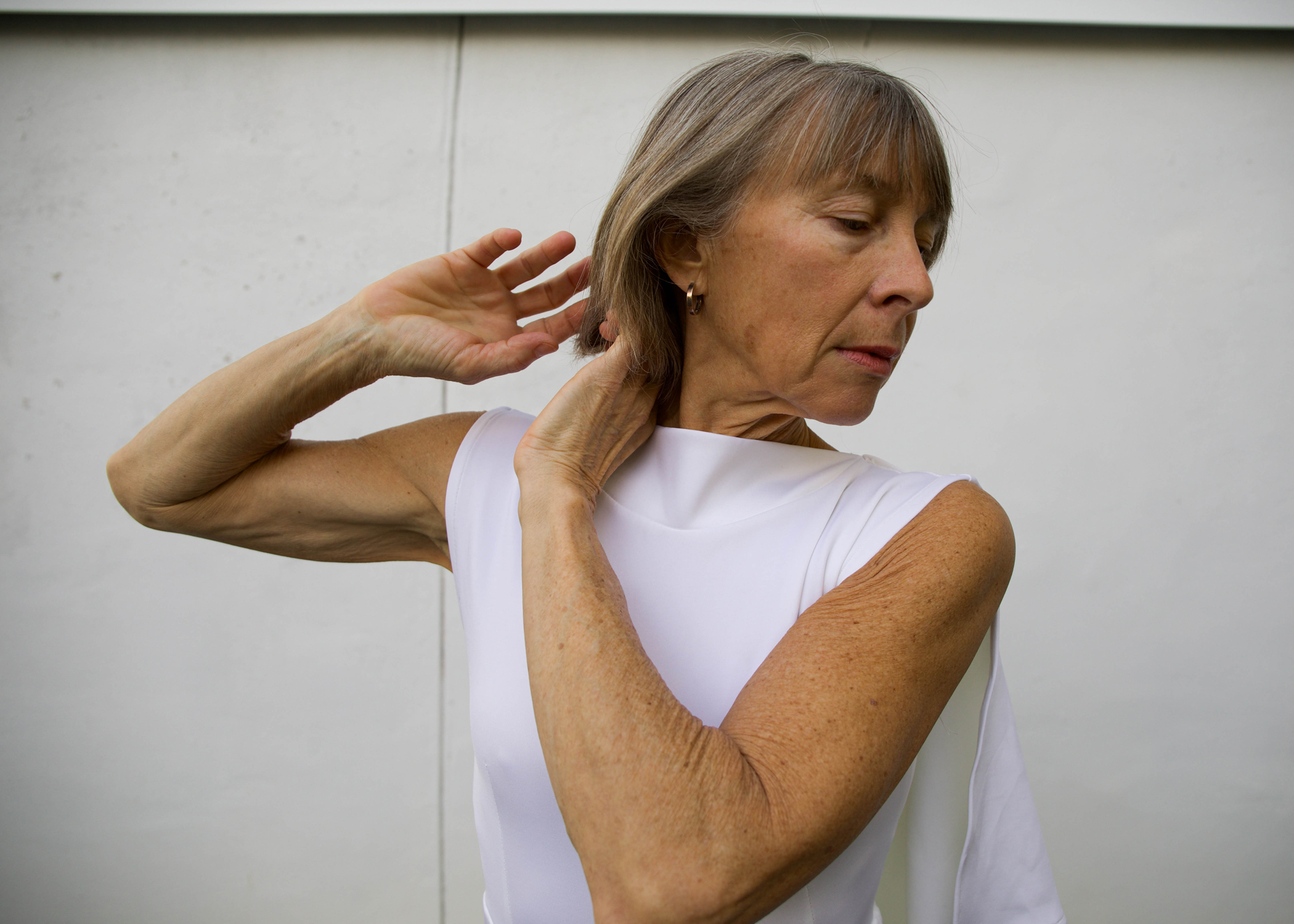 headshot of Lisa Race wearing white against a white backdrop